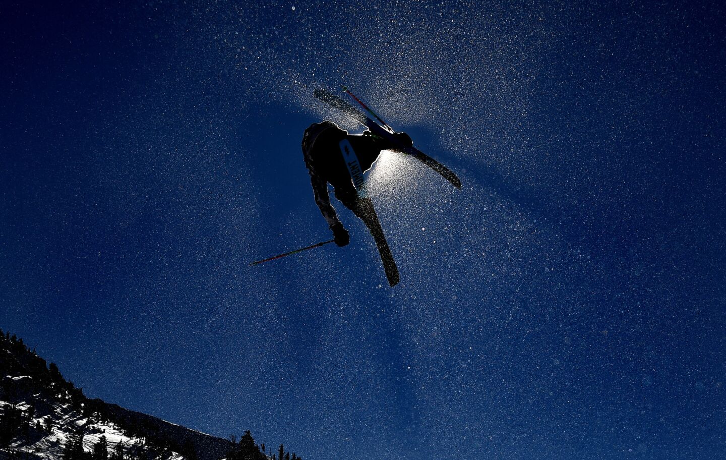 A competitor launches off a ramp during the Men's Slopestyle Qualifier in Mammoth Mountain.