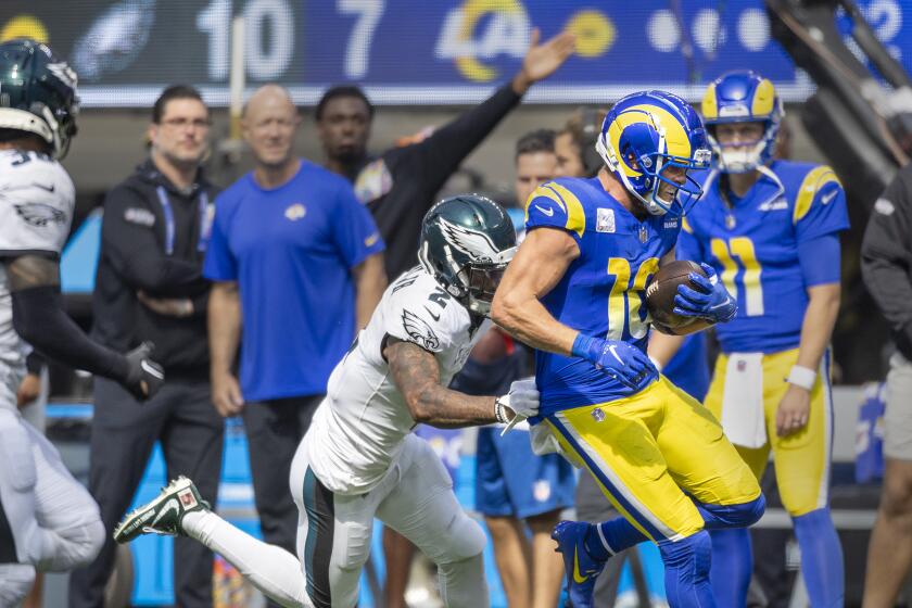 Rams receiver Cooper Kupp runs past  Eagles cornerback Darius Slay after making a catch.