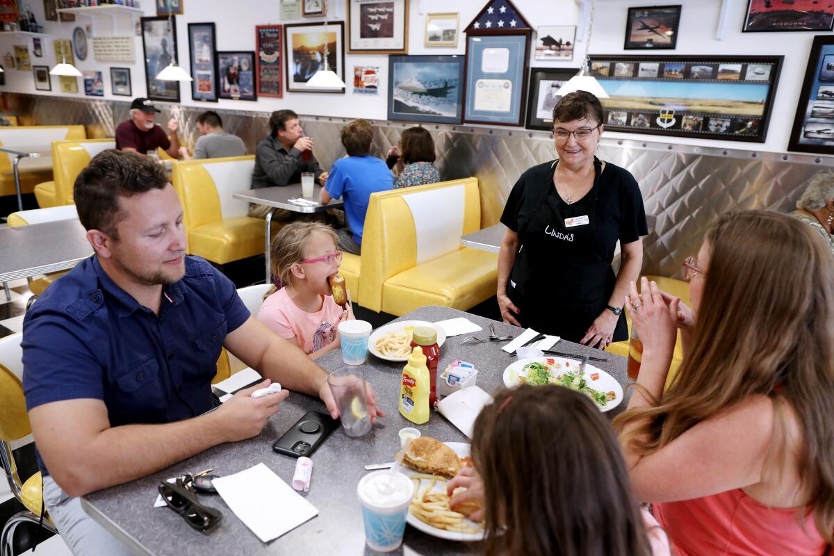 Tracy Manley, center, waits on Ruslan Batko of Yuba City; his wife, Angela Batko; and their twin 7-year-old daughters, Avery, facing, and Audrey, at Linda's Soda Bar and Grill in Yuba City.