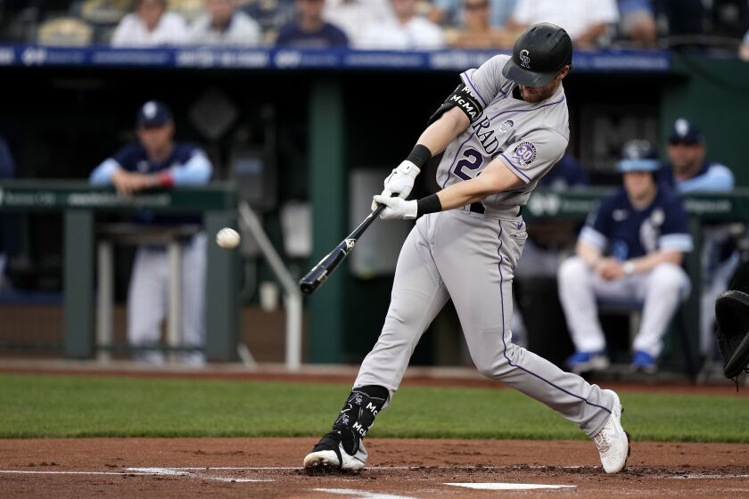 Colorado Rockies' Ryan McMahon hits a solo home run during the first inning of a baseball game against the Colorado Rockies Friday, June 2, 2023, in Kansas City, Mo. (AP Photo/Charlie Riedel)