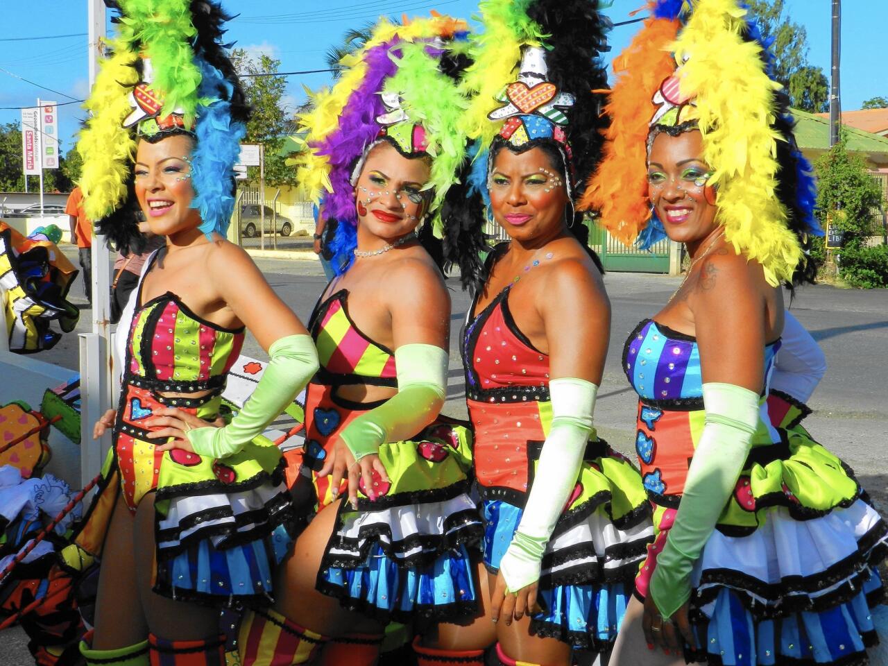 Curacao Carnival ladies parade in colorful costumes.