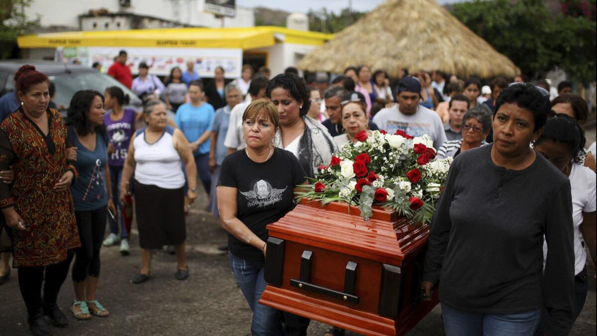 Members of a group dedicated to searching for people who have been "disappeared" carry the coffin of Pedro Huesca, whose remains were found in a mass grave in Veracruz state last year, at his funeral.