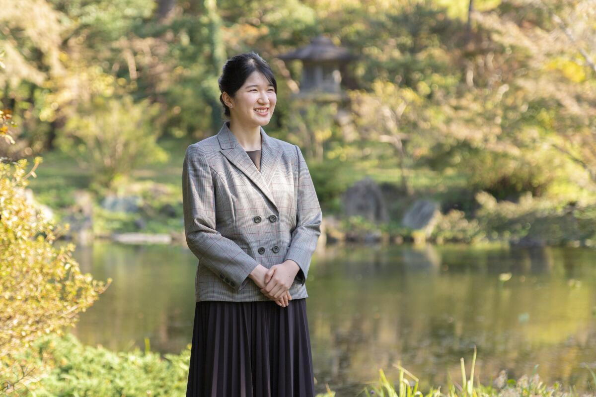 In this photo provided by the Imperial Household Agency of Japan, Princess Aiko, daughter of Emperor Naruhito and Empress Masako, strolls in the garden of the Imperial Residence at the Imperial Palace in Tokyo on Nov. 14, 2021, ahead of her 20th birthday on Dec. 1, 2021. (The Imperial Household Agency of Japan via AP)