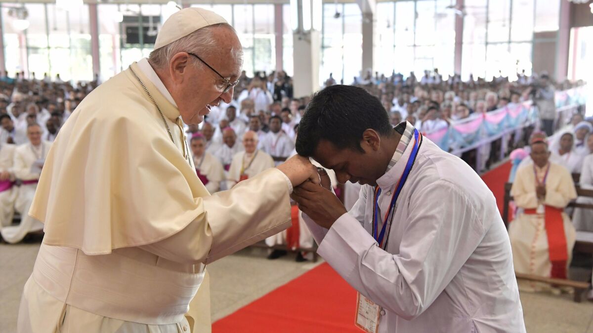 Pope Francis is greeted during his meeting Saturday with Bangladeshi prelates in Dhaka.