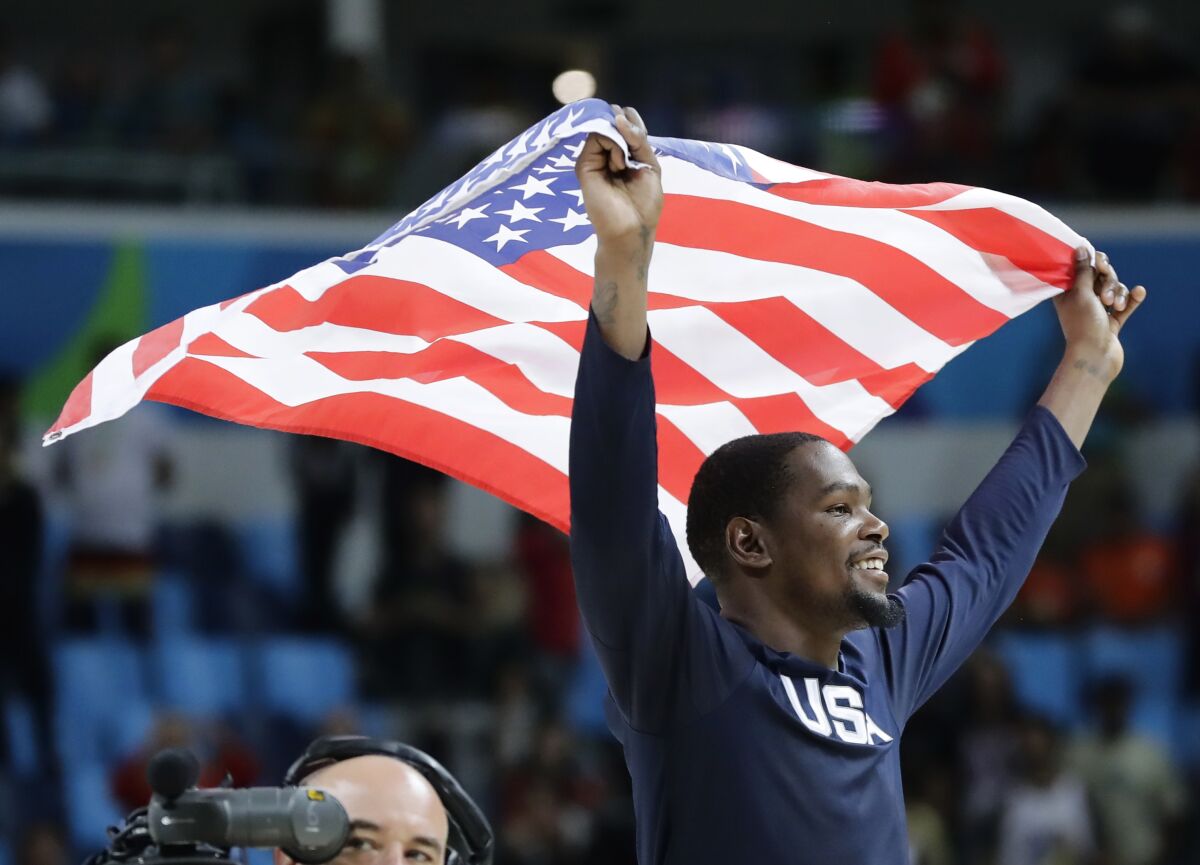 FILE - In this Aug. 21, 2016, file photo, United States' Kevin Durant celebrates after the team won gold in men's basketball at the Summer Olympics in Rio de Janeiro. Durant and coach Gregg Popovich will lead the U.S. team into the Tokyo Olympics as the Americans try to secure a fourth consecutive gold medal.(AP Photo/Matt York, File)