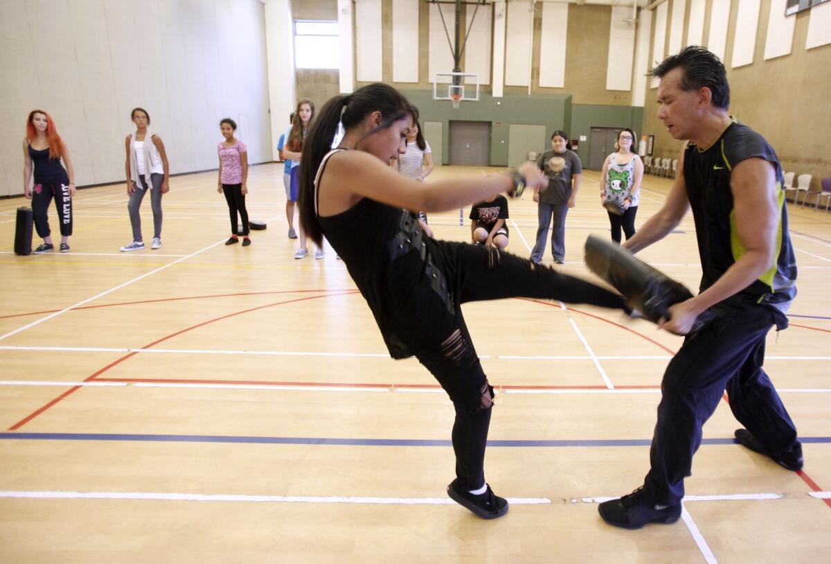 Alexandria Meneses, 15, of Burbank, learns self-defense techniques from instructor Nelson Nio at Pacific Community Center in Glendale on Tuesday, July 16, 2013.