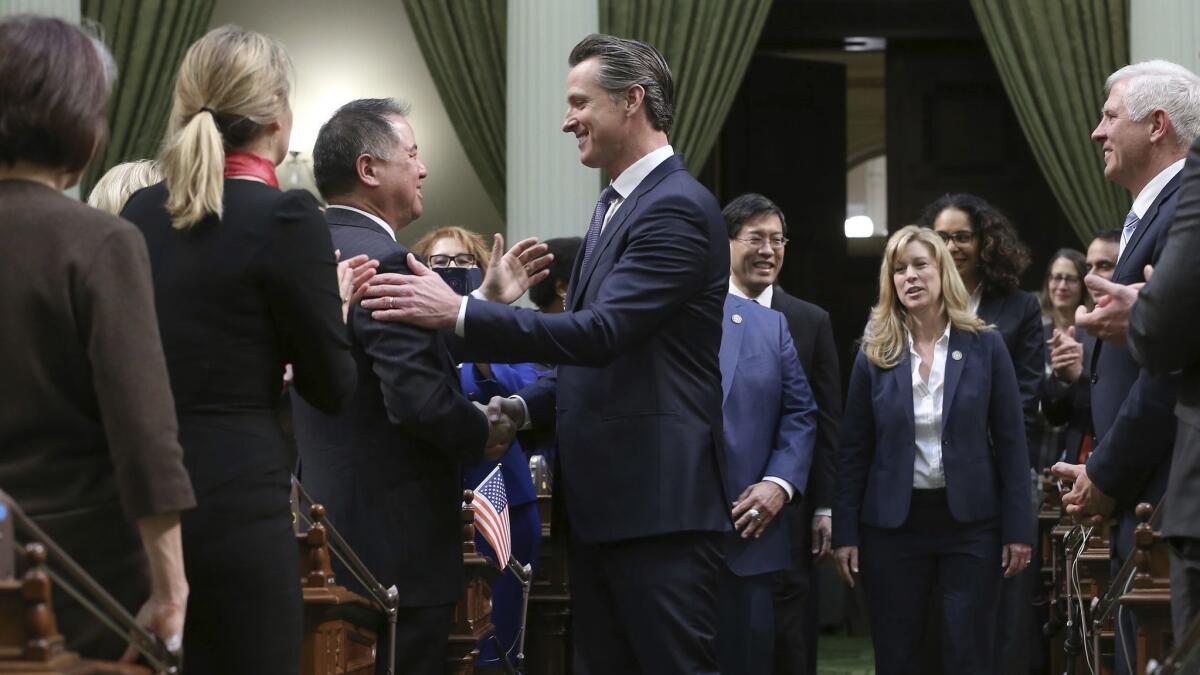 Gov. Gavin Newsom, center, shakes hands with Assemblyman Phil Ting (D-San Francisco) before Newsom's Feb. 12 State of the State address.