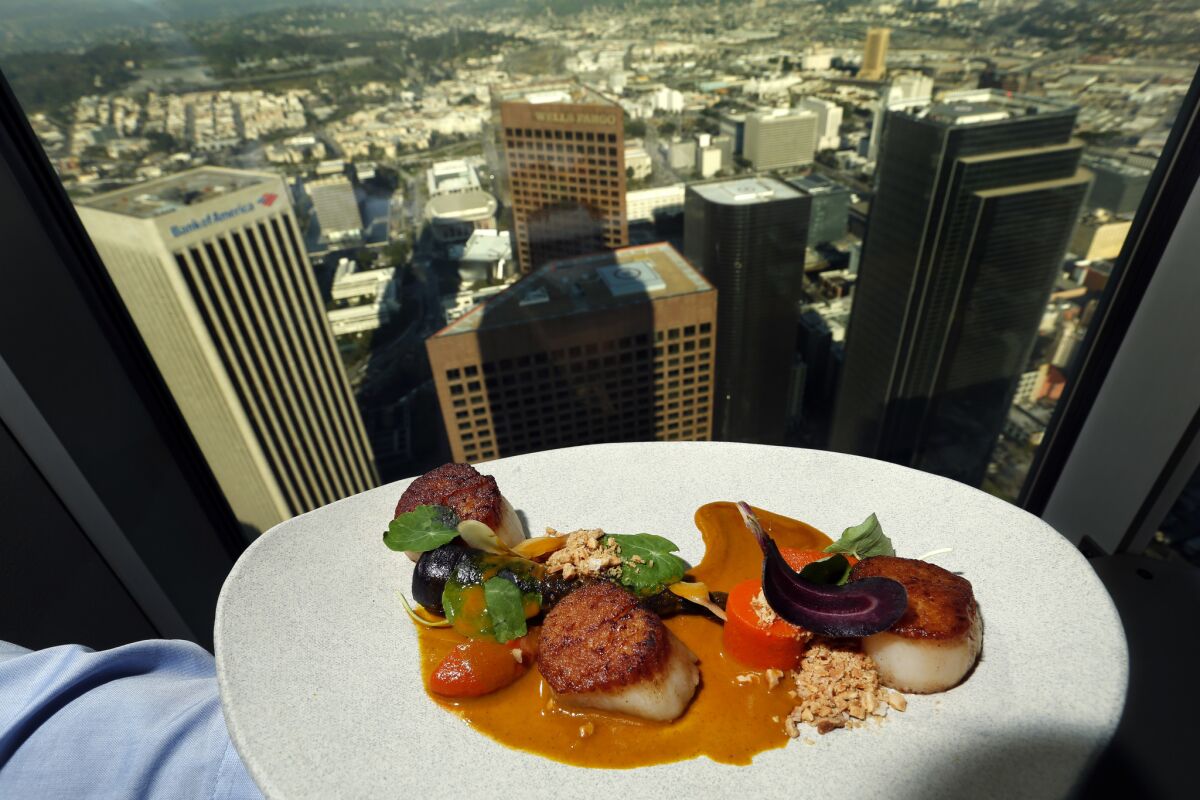 At 71Above, scallops, carrots, vadouvan curry, coconut and barrel-aged fish sauce, plus the view from the 71st floor.