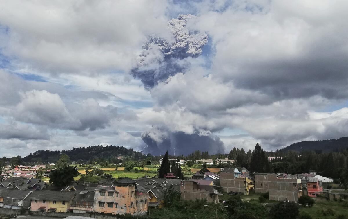 Indonesia's Mount Sinabung spews volcanic materials into the air Monday.