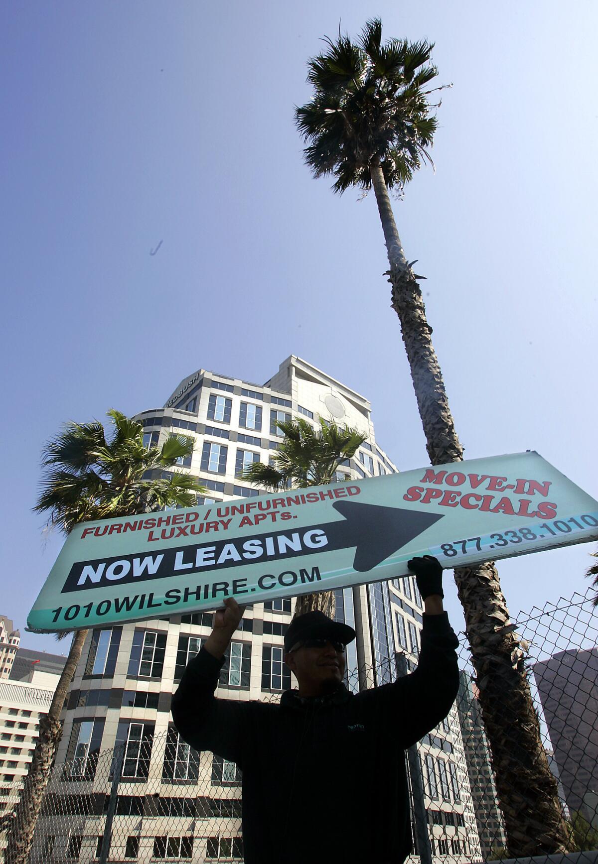 A sign twirler advertises apartments for rent in downtown Los Angeles.