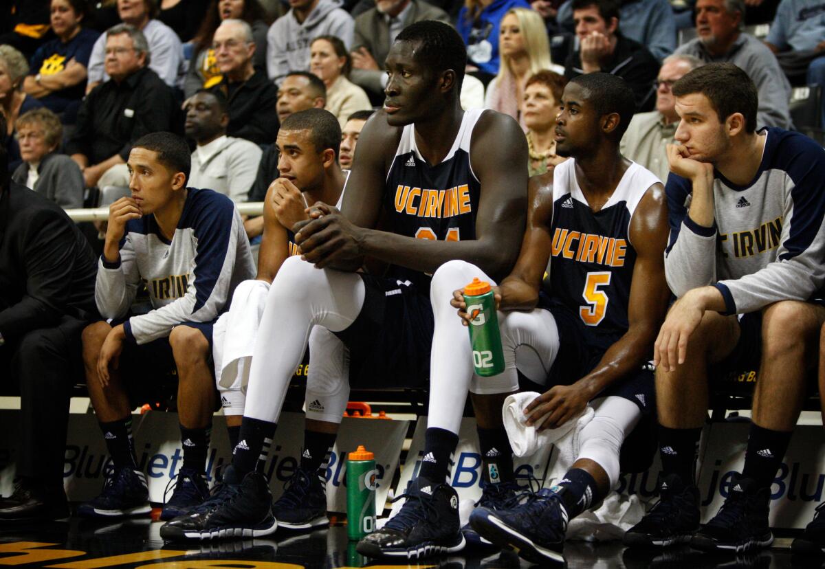 Mamadou Ndiaye, center, sits on the bench with his teammates.