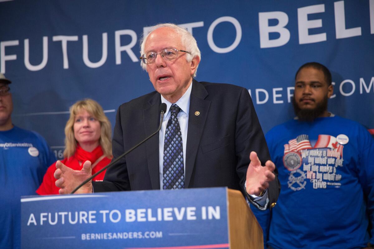 Democratic presidential candidate Sen. Bernie Sanders appears with union workers in Lansing, Mich., to object to Hillary Clinton's trade policies.