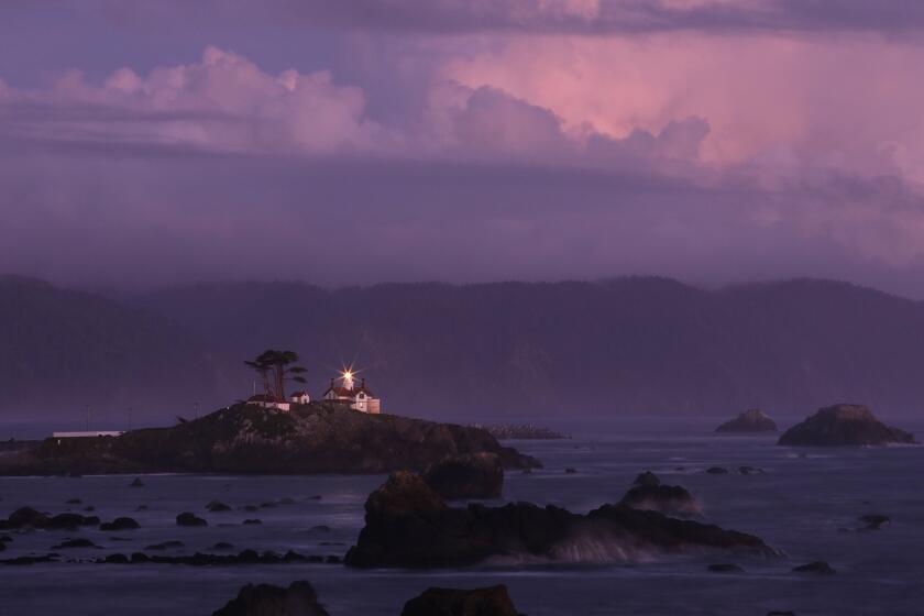 CRESCENT CITY, CA -- SEPTEMBER 18, 2019: The beacon at Battery Point Lighthouse and Museum shines at sunset. The 10-year plan for the Crescent City Harbor District, one of few economic engines in rural Del Norte County, is grim. The isolated area has an aging population. It's hard to get there. There's nothing to do. It's threatened by sea level rise. On top of it all, there's the threat of tsunamis, which wiped out the harbor in 2011. Crescent City has tried to make the best of a frustrating situation. (Myung J. Chun / Los Angeles Times)