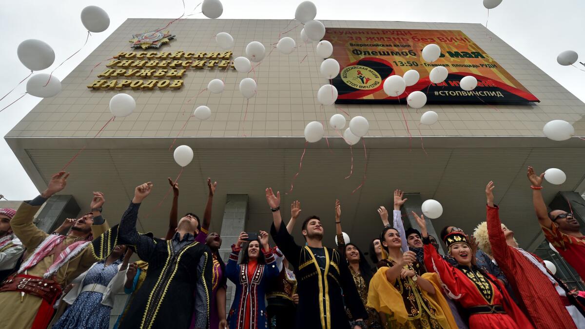 Students wearing traditional outfits release white balloons during an HIV/AIDS awareness rally in at the University of Peoples' Friendship in Moscow in May. (Kirill Kydryavtsev / AFP/Getty Images)