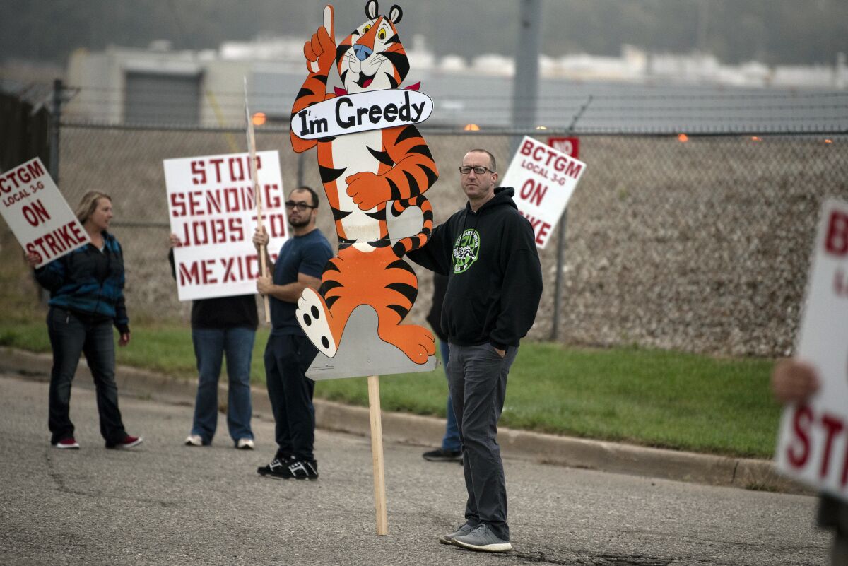 First shift worker Travis Huffman joins other BCTGM Local 3G union members in a strike against Kellogg Co., Tuesday, Oct. 5, 2021, outside the Kellogg plant on Porter Street in Battle Creek, Mich. Workers in Battle Creek, Lancaster, Memphis and Omaha walked out at 1 a.m. Tuesday,, demanding livable wages and better benefits. (Alyssa Keown/Battle Creek Enquirer via AP)