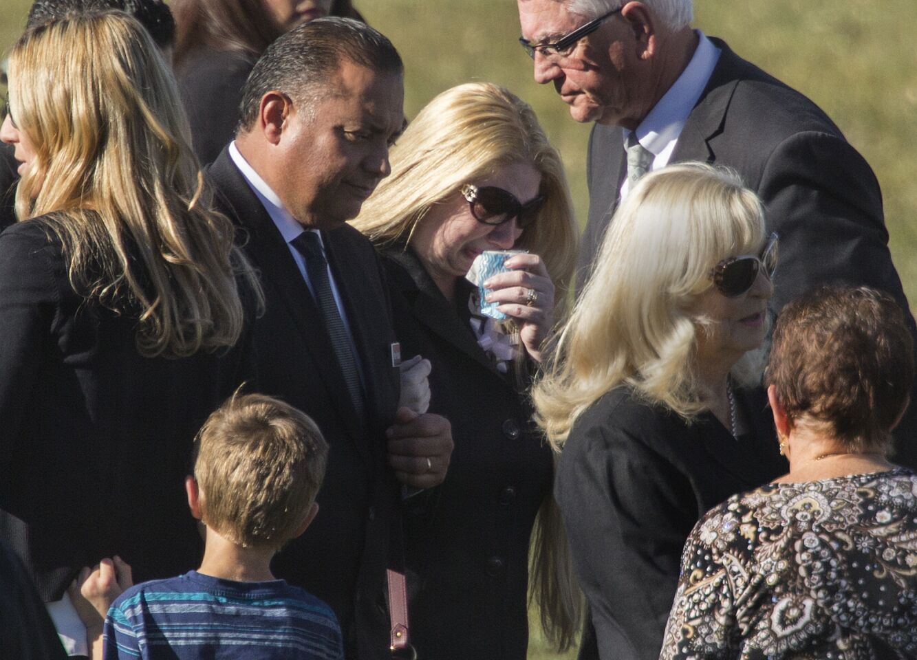 Summer Adams, center, grieves at the graveside ceremony for her husband, Robert Adams, at Montecito Memorial Park in Colton.