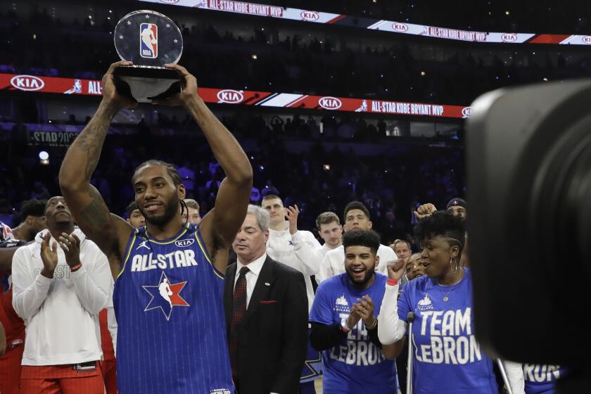 Kawhi Leonard of the Los Angeles Clippers holds up his NBA All-Star Game Kobe Bryant MVP Award after the NBA All-Star basketball game Sunday, Feb. 16, 2020, in Chicago. (AP Photo/Nam Huh)