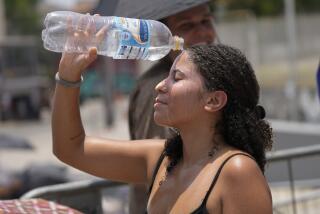 Taylor Swift fan cools off with a bottle of water amid a heat wave before The Eras Tour concert outside Nilton Santos Olympic stadium in Rio de Janeiro, Brazil, Saturday, Nov. 18, 2023. A 23-year-old Taylor Swift fan died at the singer's Eras Tour concert in Rio de Janeiro Friday night, according to a statement from the show's organizers in Brazil. (AP Photo/Silvia Izquierdo)