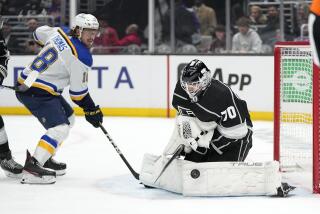 Kings goalie Joonas Korpisalo stops a shot as Blues center Robert Thomas looks on during the first period March 4, 2023.