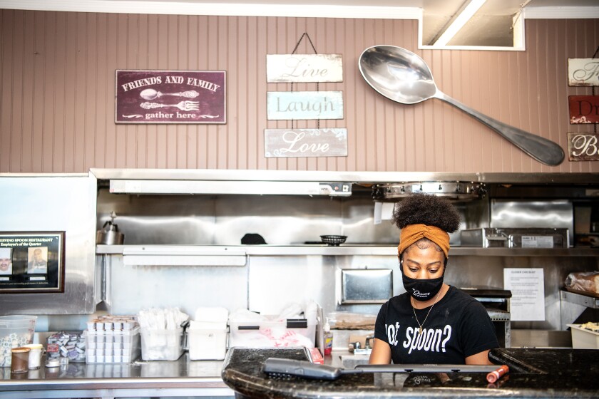 Employee Kayla Williams works inside The Serving Spoon in Inglewood.