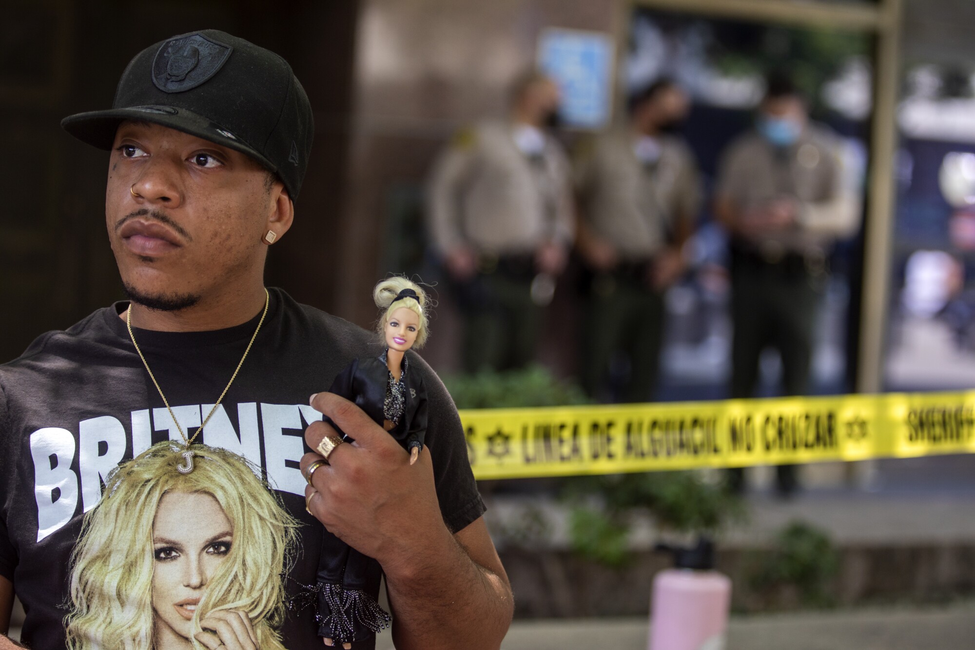 Derrick Daniels, 32, of Las Vegas holds a Britney Spears doll outside an L.A. courthouse .