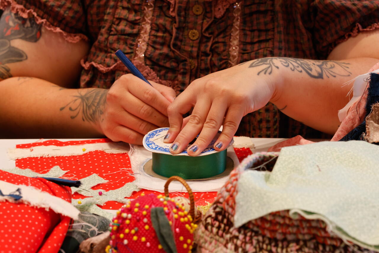 A woman works on a craft project.