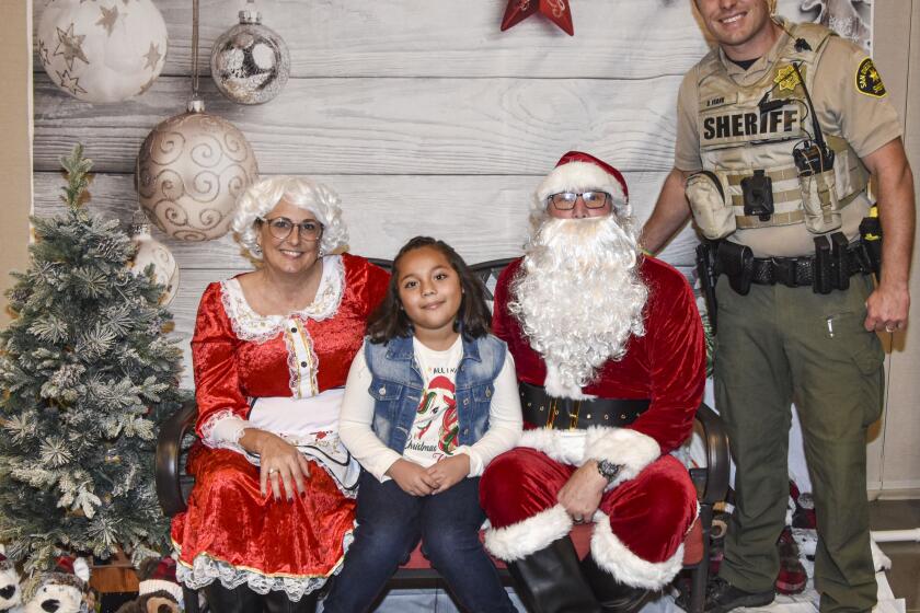 Cathleen Post, Mrs. Claus; Isabel Barragan, Ken Post, Santa Claus; and hero Det. Donnie Frank, Sheriff's Poway Station.
