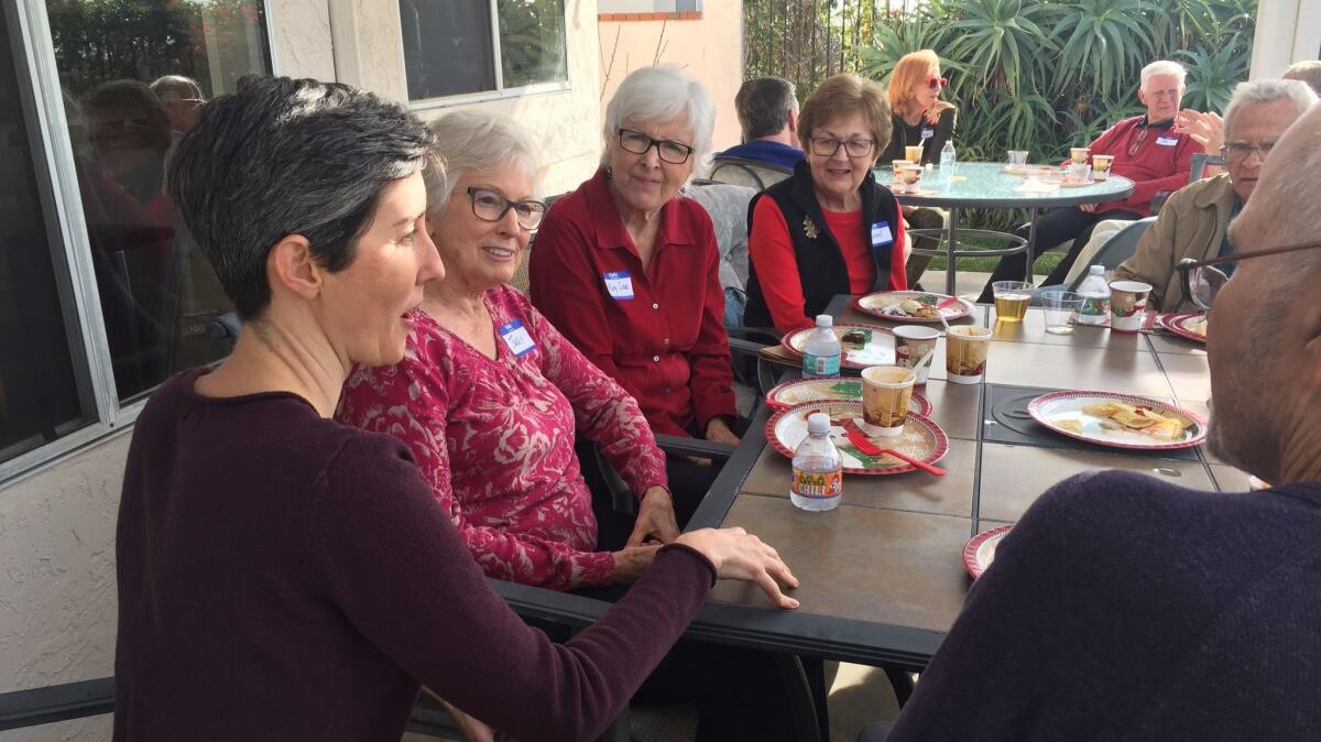 Tremble Clefs director Kathleen Hansen, left, with members of the North County choir at their annual holiday party last week in Carlsbad.