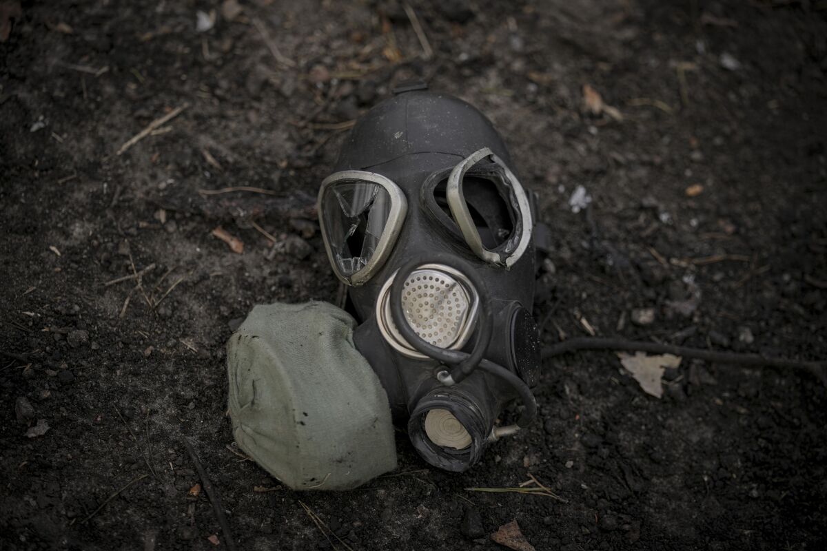 FILE - A damaged gas mask lies on the pavement at a Russian position which was overran by Ukrainian forces, outside Kyiv, Ukraine, March 31, 2022. Russia’s assault on Ukraine and its veiled threats of using nuclear arms have policymakers questioning how the West should respond to a Russian battlefield explosion of a nuclear bomb. The default U.S. policy answer, say some architects of the post-Cold War nuclear order, is with discipline and restraint. (AP Photo/Vadim Ghirda, File)