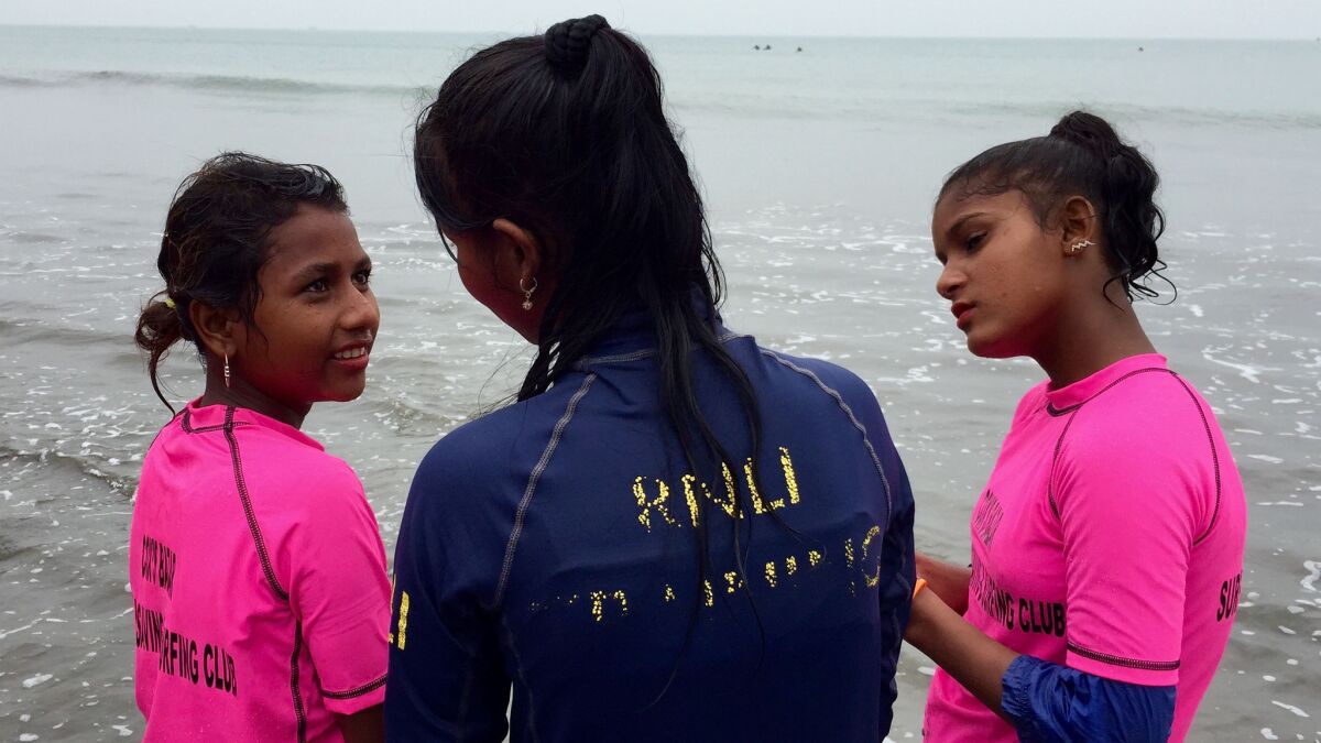 Friends Aisha, 11, Sumi, 13, and Shoma Akthar, 14, are some of the girls surfing together in Cox's Bazar.