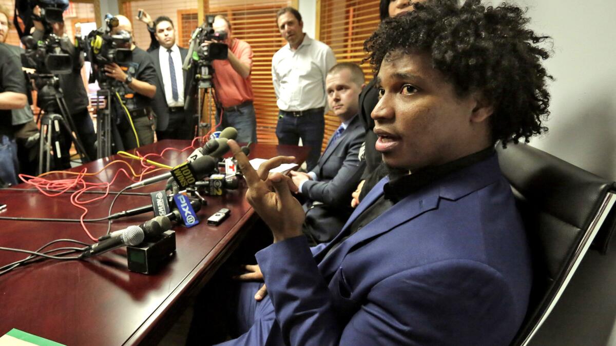 Former Mets pitcher Jenrry Mejia, right, addresses a news conference at the office of his attorney Vincent White on Friday.