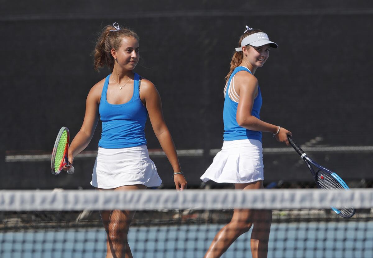 Corona del Mar's Cate Montgomery and Lauren Jones, from left, play doubles during Tuesday's match against Peninsula.