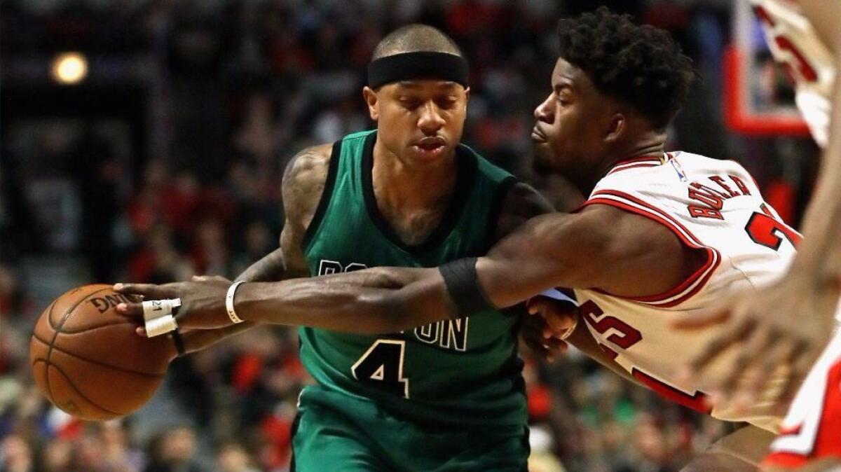 Jimmy Butler (21) of the Chicago Bulls tries to knock the ball away from Celtics guard Isaiah Thomas (4) on Feb. 16.