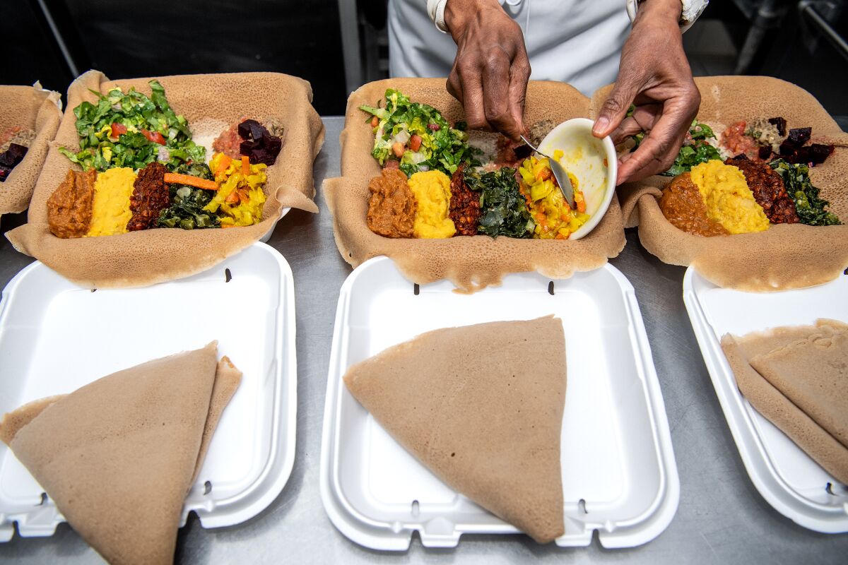 Genet Agonafer of Meals by Genet prepares takeout orders.