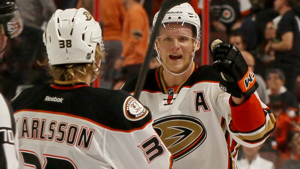 Ducks forward William Karlsson, left, is congratulated by teammate Corey Perry after scoring the winning shootout goal in a 4-3 win over the Philadelphia Flyers on Tuesday.