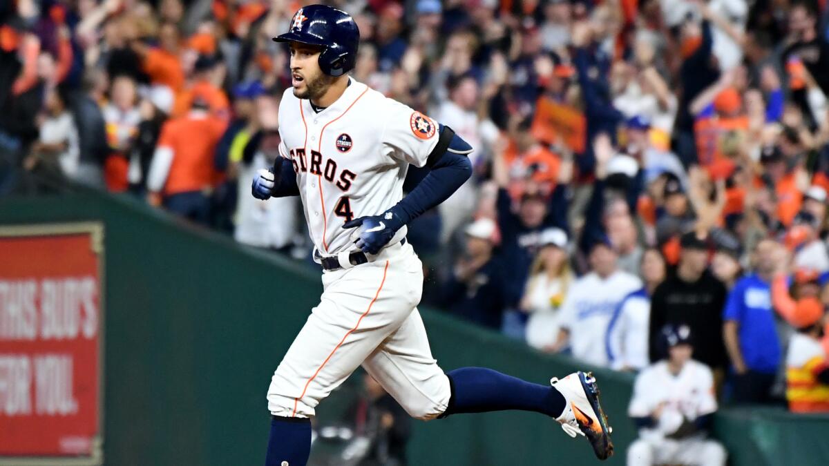 Astros center fielder George Springer rounds the bases after hitting a solo home run against the Dodgers during the sixth inning of Game 4.