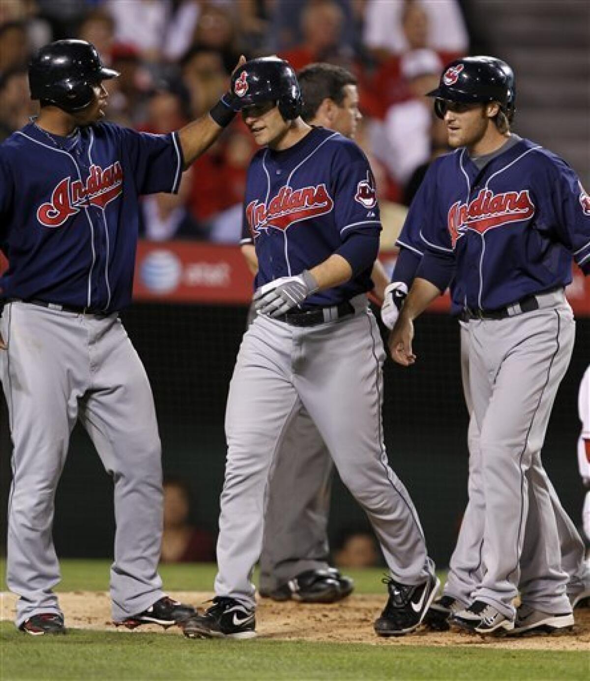 Cleveland Indians' Lou Marson, second from left, gets a pat on the head from Jordan Brown, left, after Marson hit a grand slam in the sixth inning of a baseball game against the Los Angeles Angels on Tuesday, Sept. 7, 2010, in Anaheim, Calif. (AP Photo/Alex Gallardo)