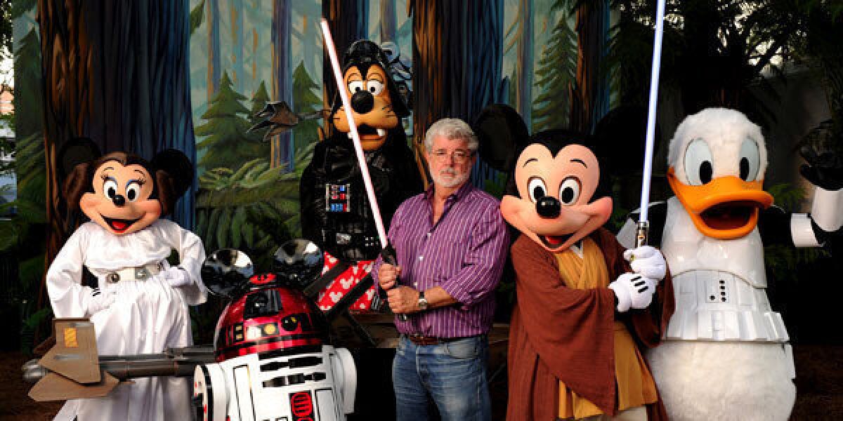 "Star Wars" creator and filmmaker George Lucas poses with a group of "Star Wars"-inspired Disney characters.