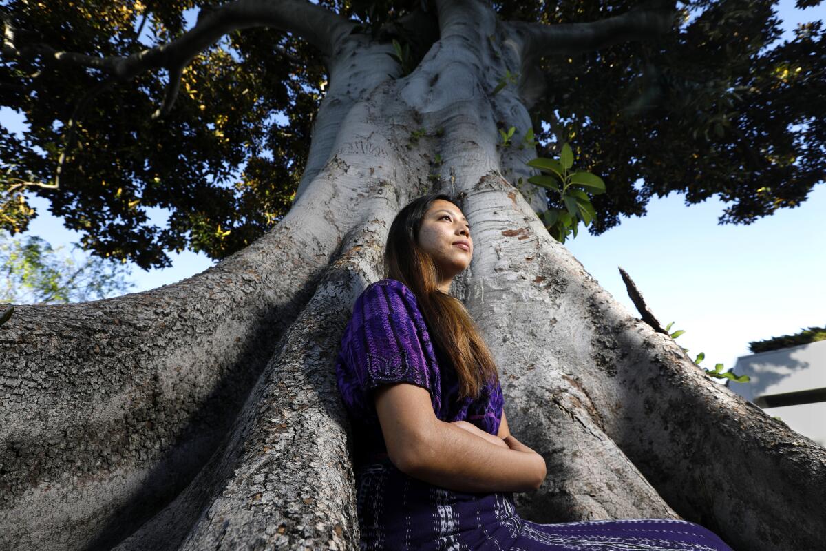 Alba Gonzalez stands by a tree