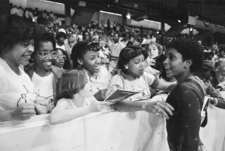 Dianne Durham, 15, of Gary, Ind., right, signs autographs after winning the women's title.