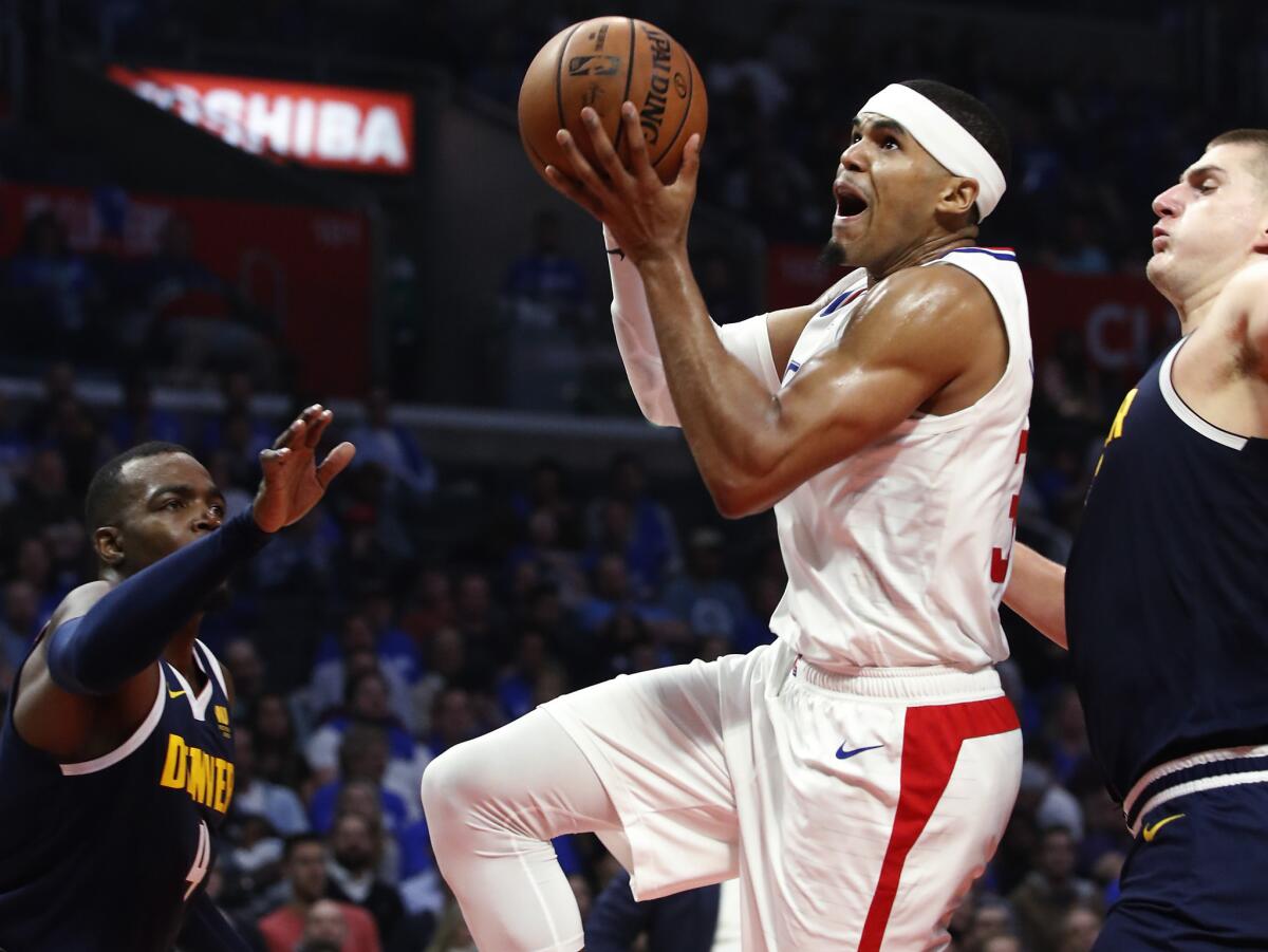 Clippers forward Tobias Harris, driving for a layup against Denver on opening night, is having a career year this season.