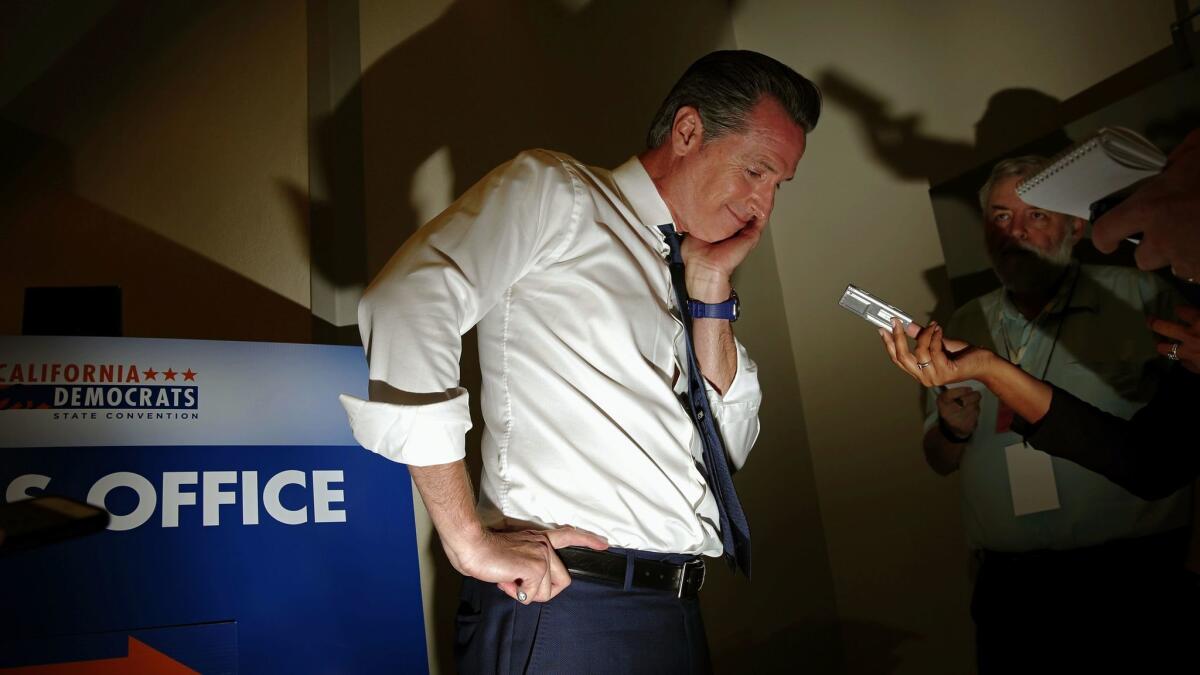 Lt. Gov. Gavin Newsom speaks with reporters at the California Democratic Party convention in Sacramento on Friday.