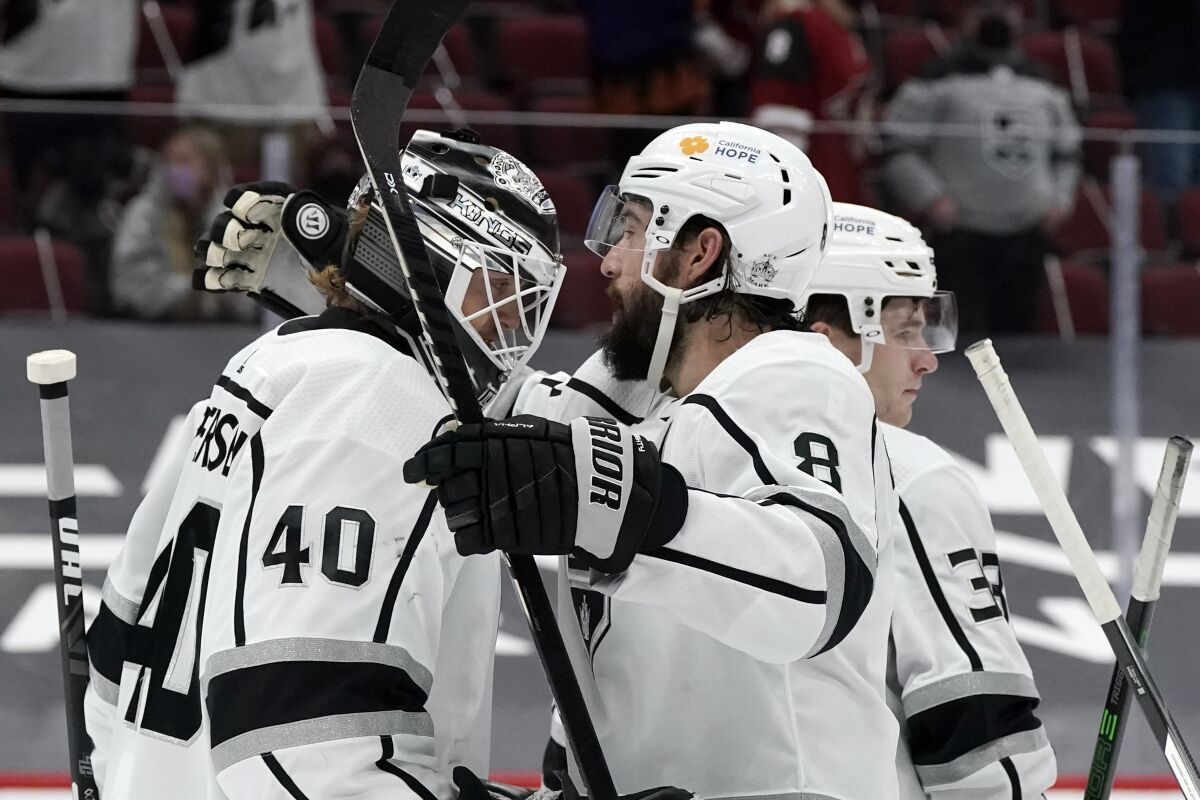 Kings goalie Cal Petersen is congratulated by defenseman Drew Doughty (8) on Feb. 20, 2021, in Glendale, Ariz.