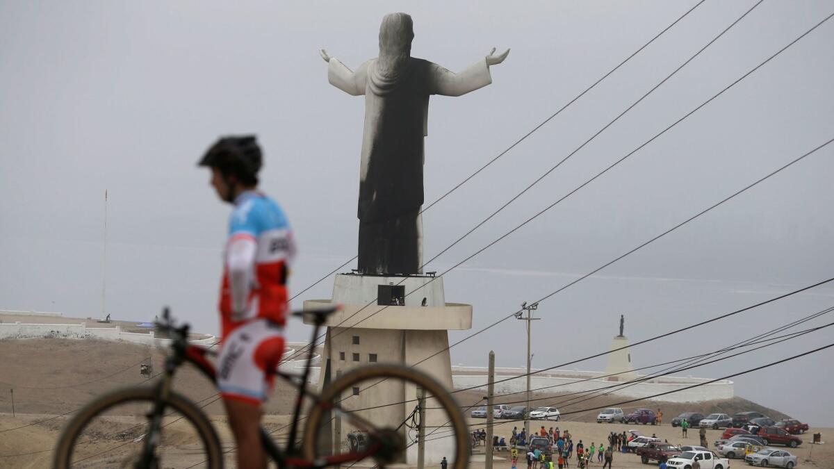 The Christ of the Pacific statue in Lima, Peru, is scorched by soot on Jan. 13, 2018.