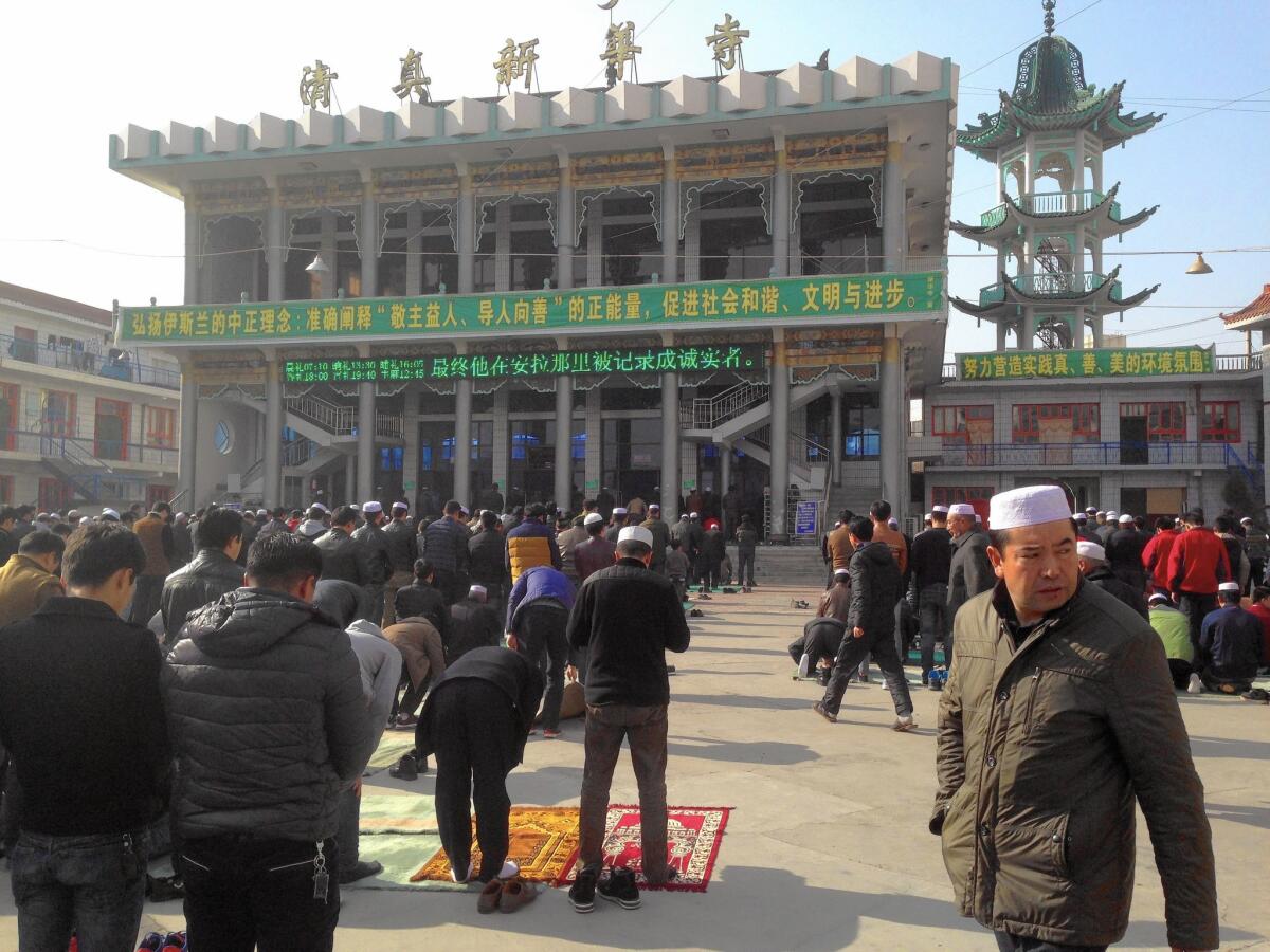 People converge on the Xinhua Mosque in Linxia, China, for Friday prayers.