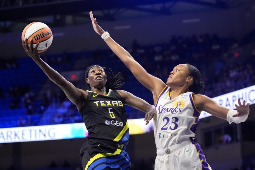 Dallas Wings forward Natasha Howard (6) leaps to the basket for a shot as Los Angeles Sparks' Azura Stevens (23) defends in the first half of a WNBA basketball game in Arlington, Texas, Saturday, July 13, 2024. (AP Photo/Tony Gutierrez)