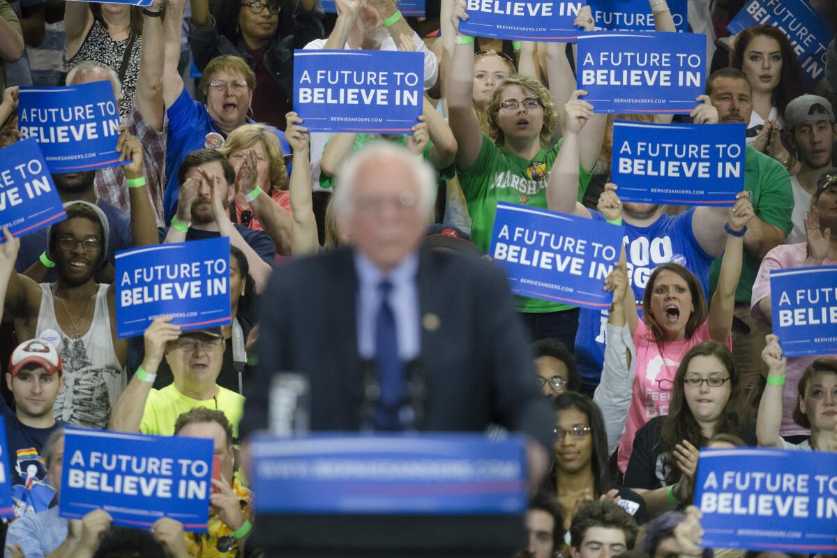Audience members cheer as Democratic presidential candidate Sen. Bernie Sanders speaks during an election night campaign event at the Big Sandy Superstore Arena on April 26 in Huntington, W.Va.