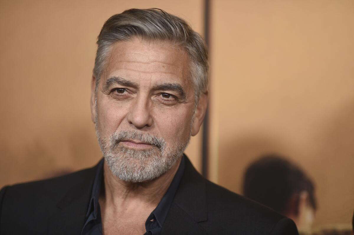 George Clooney wears a black shirt.