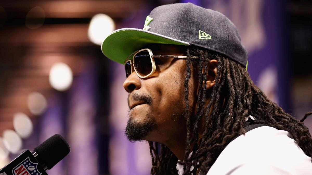Seattle Seahawks running back Marshawn Lynch addresses the media, in his own way, during Super Bowl XLIX Media Day in Phoenix on Jan. 27.
