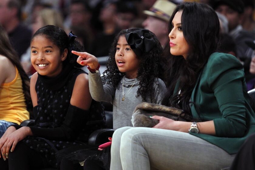 Vanessa Bryant, right, and her daughters Natalia Diamante Bryant, 9, left, and Gianna Maria-Onore Bryant, 6, center, attend an NBA basketball game between the Los Angeles Lakers and New York Knicks in Los Angeles, Tuesday, Dec. 25, 2012. The Lakers won 100-94. (AP Photo/Alex Gallardo)